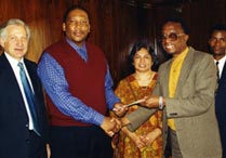 His Majesty King Letsie III, second from left, is presented with a copy of the Bahá’í International Community's statement 